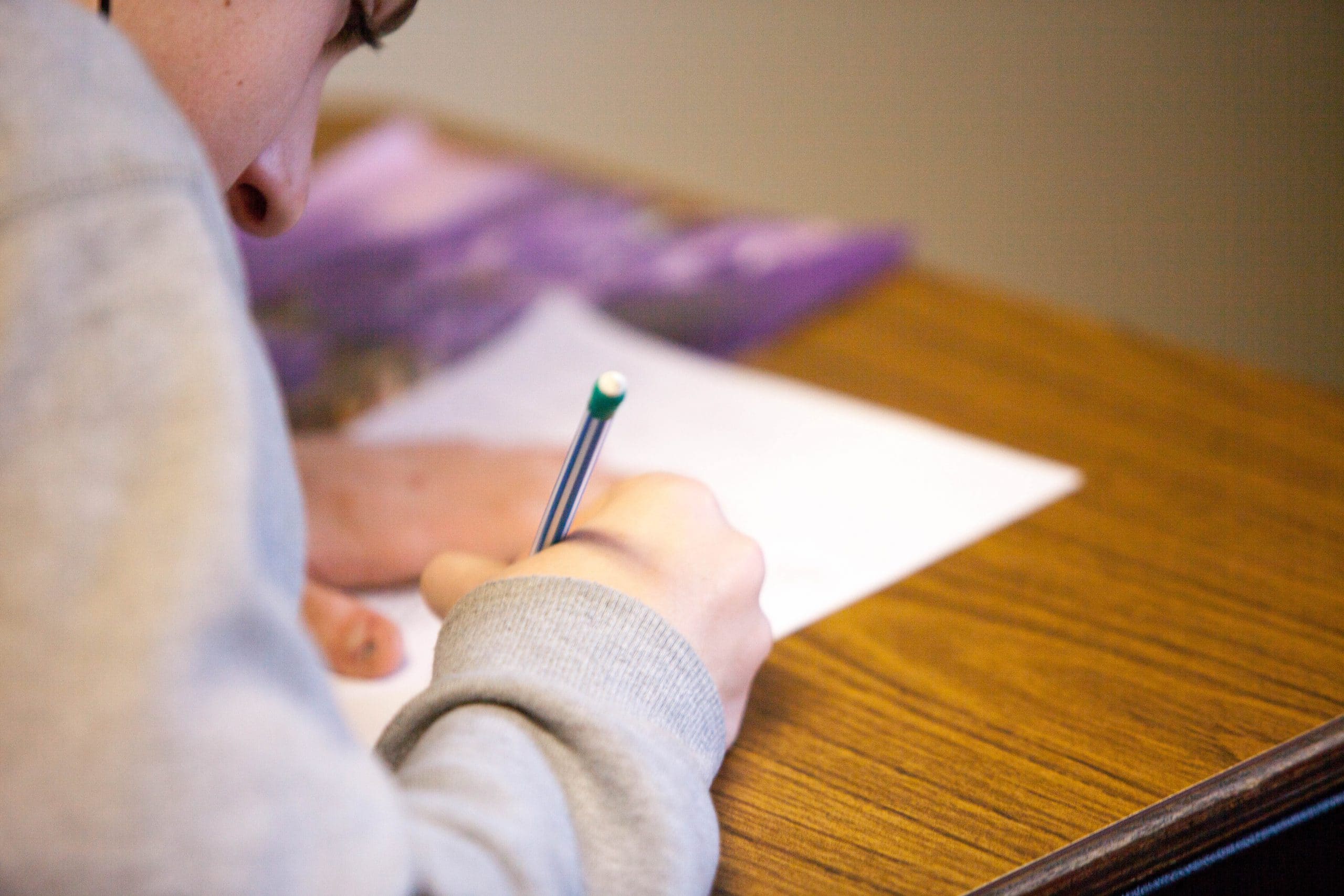 young girl writing at desk